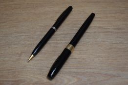 A Sheaffer Imperial IV button fill fountain pen and propelling pencil set in black with white spot