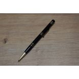 A Mabie Todd & Co Fyne Poynt propelling pencil set in black with several decorative bands.