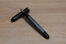 A Pelikan 140 piston fill fountain pen in green striped with black cap having Pelikan 585 14 Karat B