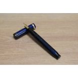 A Parker Duofold Senior Lucky Curve button fill fountain pen in lapis lazuli blue with white