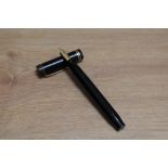 A Parker Duofold Senior Lucky Curve button fill fountain pen in black with two narrow bands to the