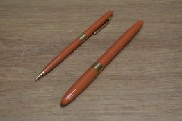 A Sheaffer Statesman snorkel fill fountain pen and propelling pencil set in mandarin with white spot