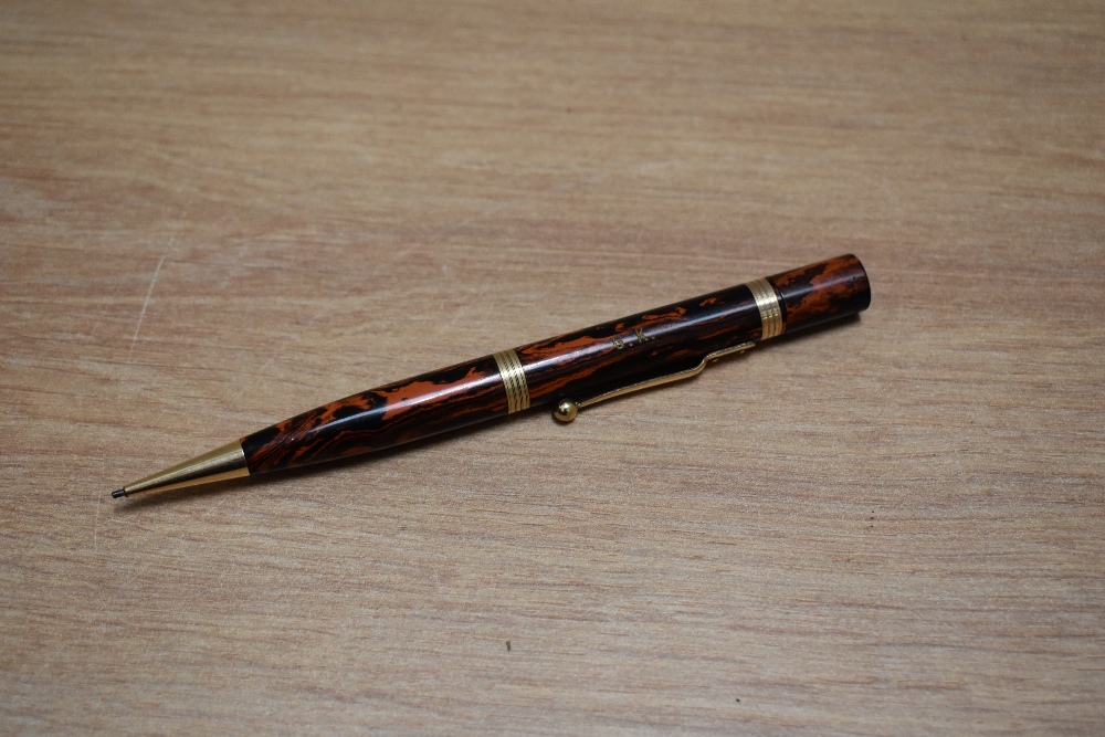 A Mabie Todd Swan Eternal propelling pencil in black and red hard rubber. Engraved