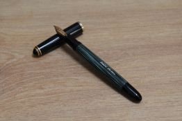 A Pelikan 400NN piston fill fountain pen in green striped with black cap having Pelikan 14C 585 nib.