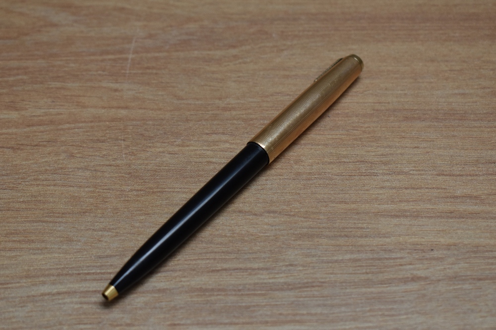 A Parker 65 ballpoint pen in black with rolled gold cap