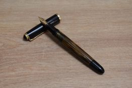 A Pelikan 400NN piston fill fountain pen in tortoise shell brown striped with black cap having