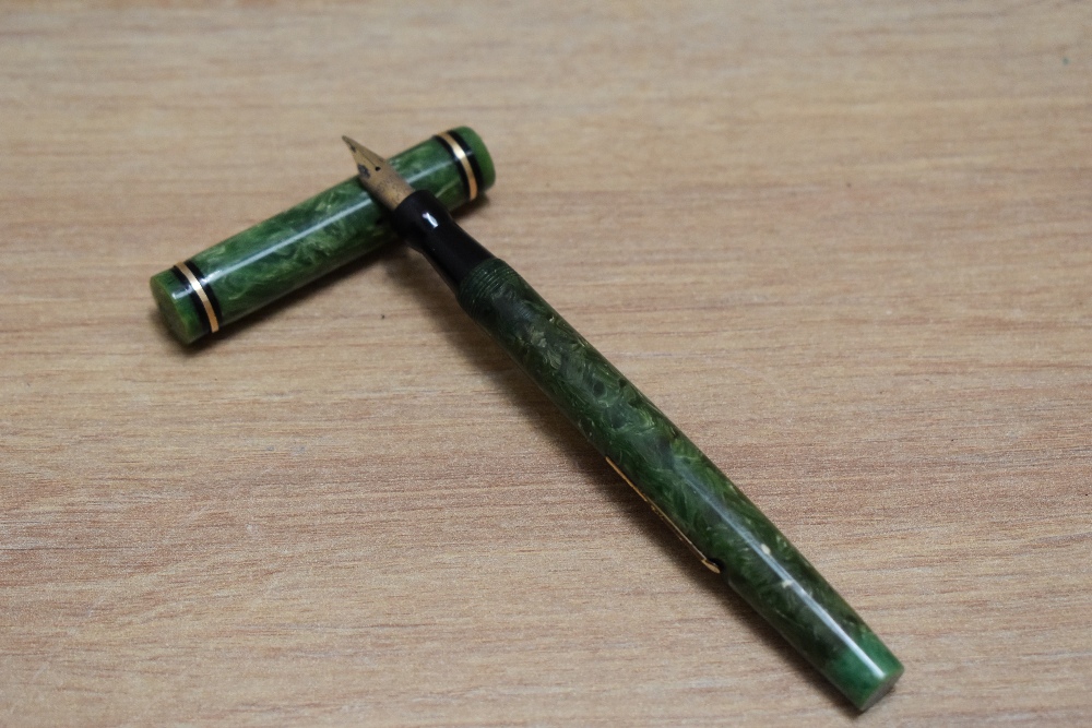 A Mabie Todd Swan Self Filler 142 50 lever fill fountain pen in jade green with gold in black band