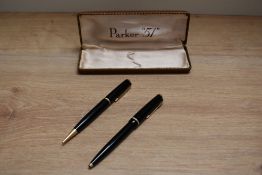A Parker Duofold ballpoint pen and propelling pencil set in black with narrow decorative band.