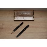 A Parker Duofold ballpoint pen and propelling pencil set in black with narrow decorative band.