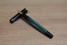 A Pelikan M200 piston fill fountain pen in green marble with black cap having Pelikan EF nib.