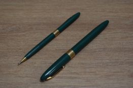 A Sheaffer Statesman snorkel fill fountain pen and propelling pencil set in fern green with white