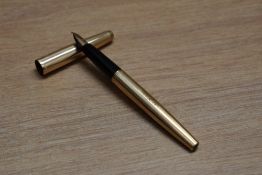 A Parker 65 aero fill fountain pen in rolled gold having Parker 14k nib. Engraved and dent to