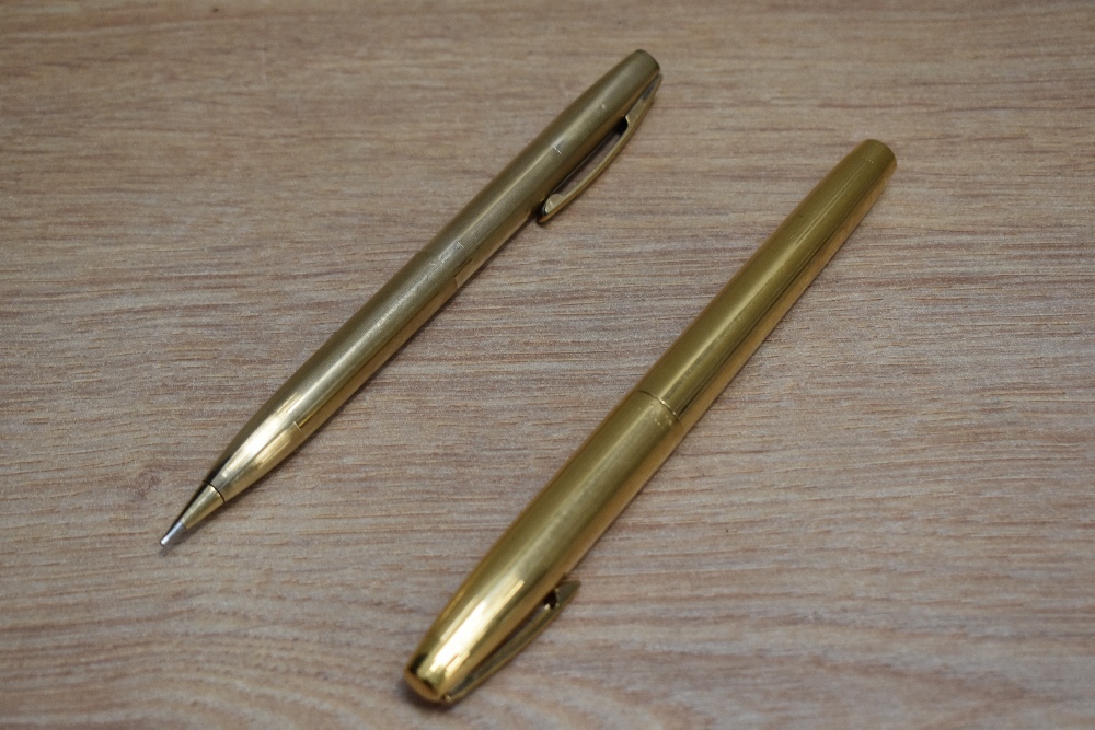 A Sheaffer Imperial 777 aerometric fill fountain pen and propelling pencil set in gold fill with