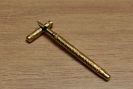 A Mabie Todd & Co Swan 1 eye dropper fountain pen in hammered yellow metal having Swan 1 K 14C 585