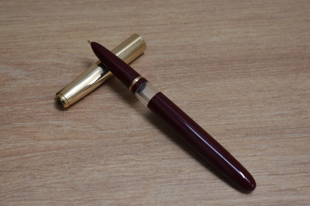 A De La Rue Onoto K1 Plunger fill fountain pen in burgundy with window in barrel and gold cap having