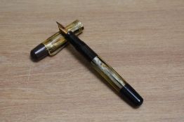 A Pelikan 101N piston fill fountain pen in tortoise with two narrow bands to the cap having