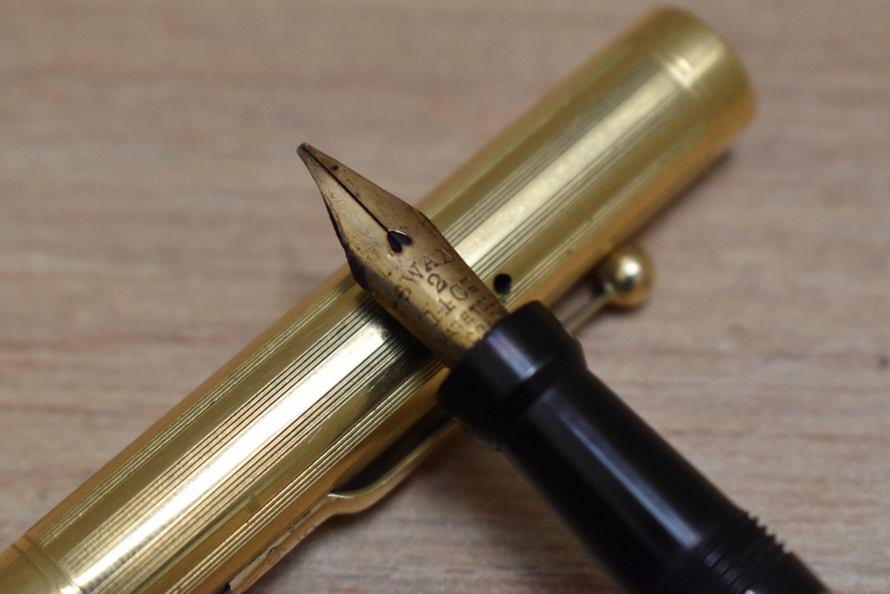 A Mabie Todd Self Filling lever fill fountain pen in yellow metal in engine turned reeded design - Image 2 of 3