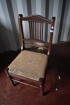 A Victorian mahogany nursing chair having turned frame