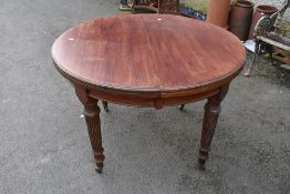 A 19th Century circular wind out dining table on fluted legs, diameter approx 106cm, plus additional