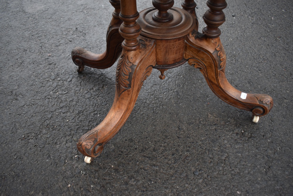 A 19th Century walnut breakfast table having inlaid oval top on quadruple turned column supports and - Image 2 of 2