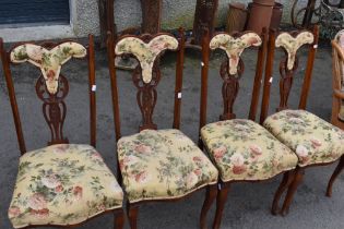 A set of four late Victorian upholstered dining chairs having mahogany frame