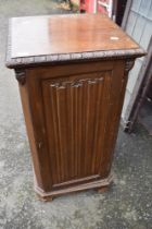 An early 20th Century mahogany pot cupboard having linen fold panels and door