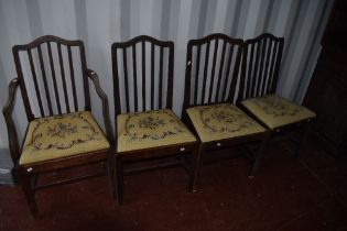 A set of four (three plus one) early 20th Century mahogany dining chairs having applique design rail