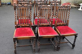 A set of six early 20th Century oak dining chairs having rail back , barley twist frames and drop in