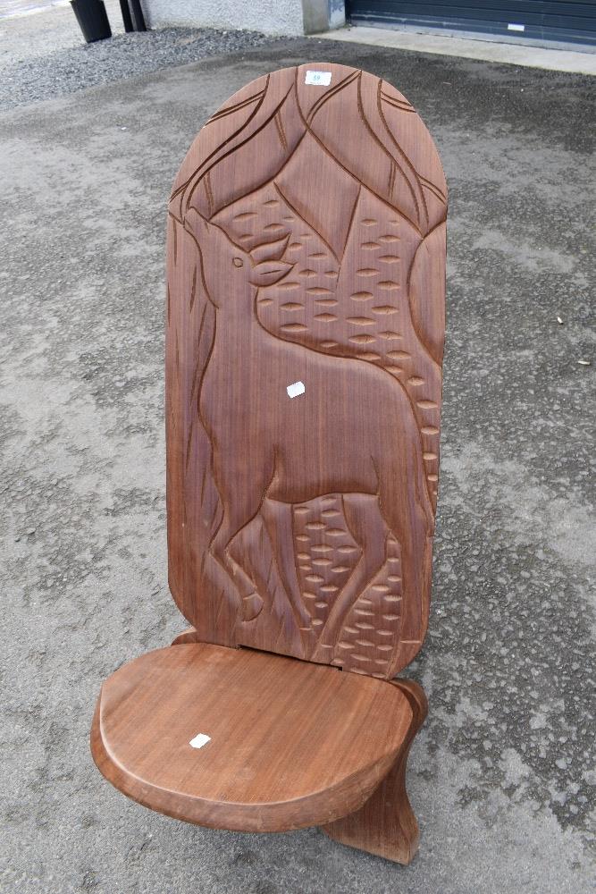 A traditional African Palaver chair havimg carved decoration, possibly Springbok