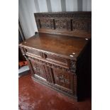 A period oak side cabinet having carved panel back , single drawer and double cupboards under, width