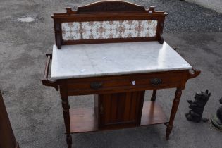 A Victorian mahogany wash stand having tiled back