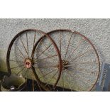 A pair of traditional metal cart wheels