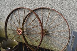 A pair of traditional metal cart wheels