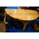A natural pine demi lune hall table on turned legs, width approx. 102cm