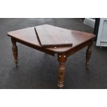 A Victorian oak wind out dining table, approx 138 x 122cm closed dimensions, with winder and