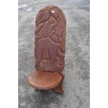 A traditional African Palaver chair havimg carved elephant decoration