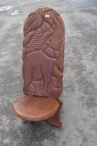 A traditional African Palaver chair havimg carved elephant decoration