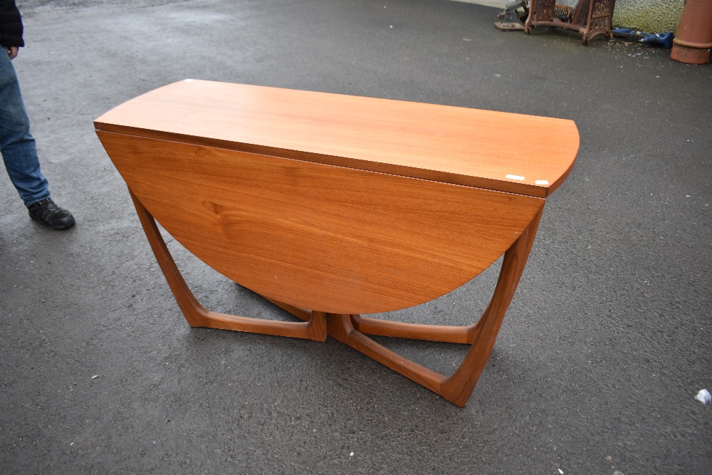 A vintage teak drop leaf table of stylised design, McIntosh style, labelled beithcraft furniture