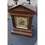 A 19th Century mantel clock in architectural case with brass and silvered roman numeral dial ,