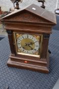 A 19th Century mantel clock in architectural case with brass and silvered roman numeral dial ,