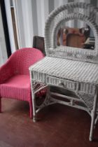 A vintage wicker dressing table and Lloyd Loom tub chair