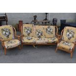 A vintage Ercol style three piece cottage suite in light stain