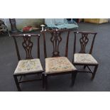 A matched set of three 19th Century mahogany dining chairs in the Hepplewhite style with drop in