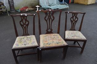 A matched set of three 19th Century mahogany dining chairs in the Hepplewhite style with drop in