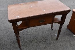 A Victorian fold over card table having frieze drawer and under shelf