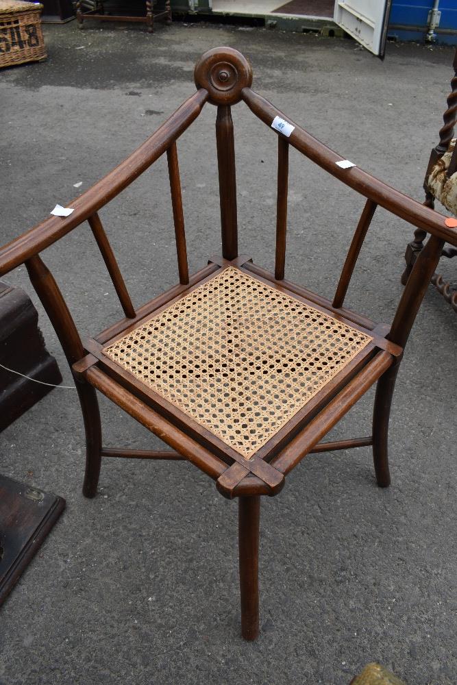 An unusal Aesthetic movement bentwood corner chair having cane seat