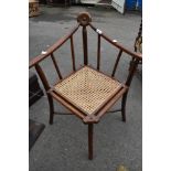 An unusal Aesthetic movement bentwood corner chair having cane seat