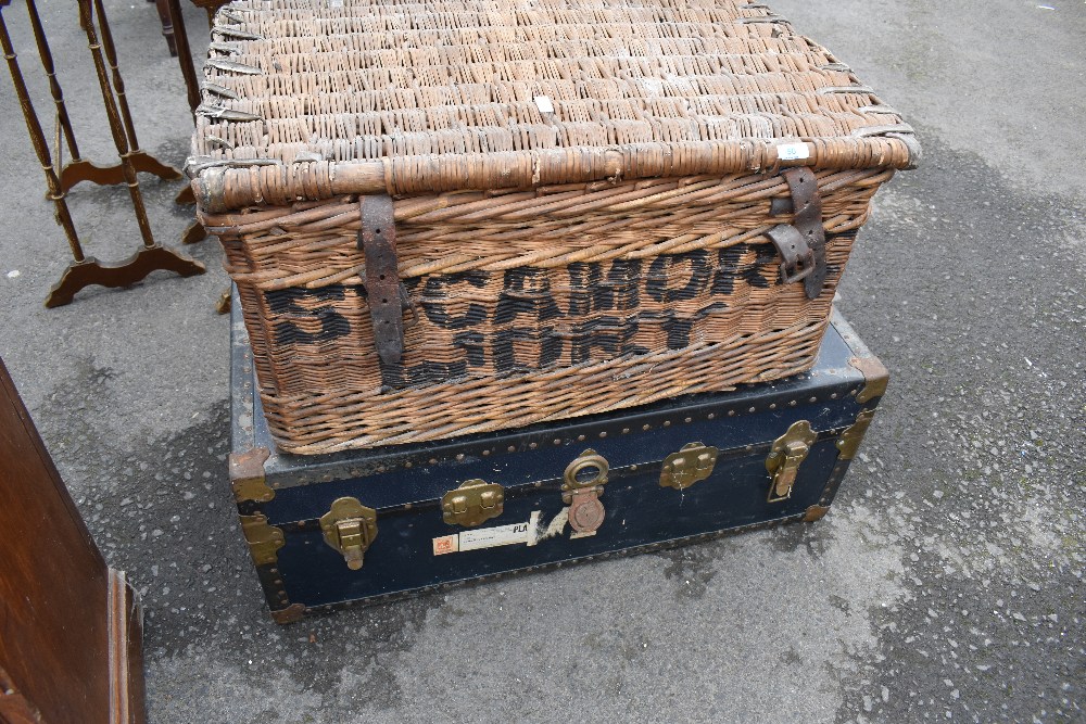 A vintage trunk and large wicker laundry or food hamper