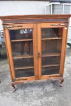 An Arts and Crafts oak bookcase with copper hinges, width 113 height 146cm