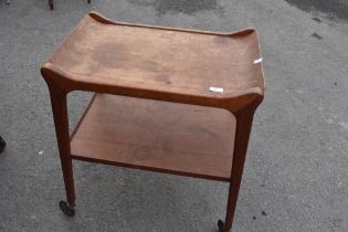 A vintage teak tea trolley having removable tray top